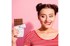 Image Woman eating chocolate.